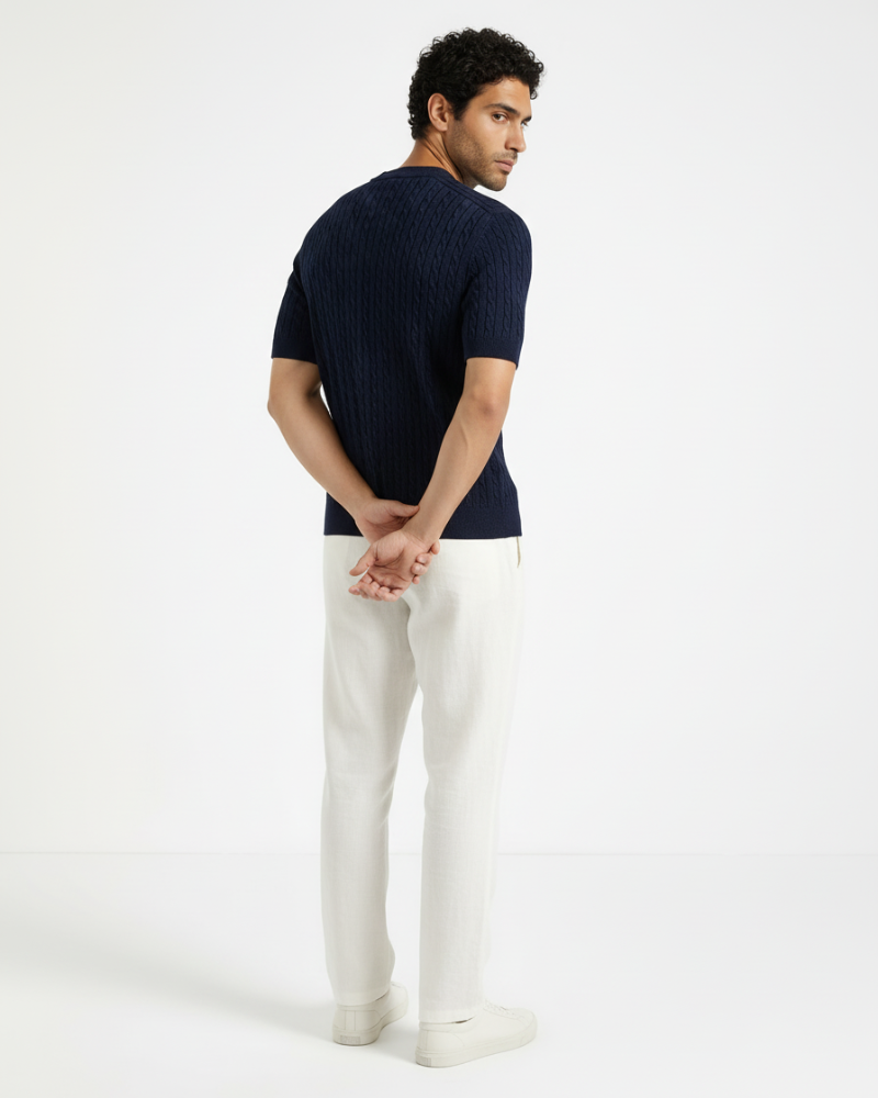 Back view of a navy wool-blend cable knit t-shirt. Luxury minimalist short-sleeve sweater with premium textured weave.