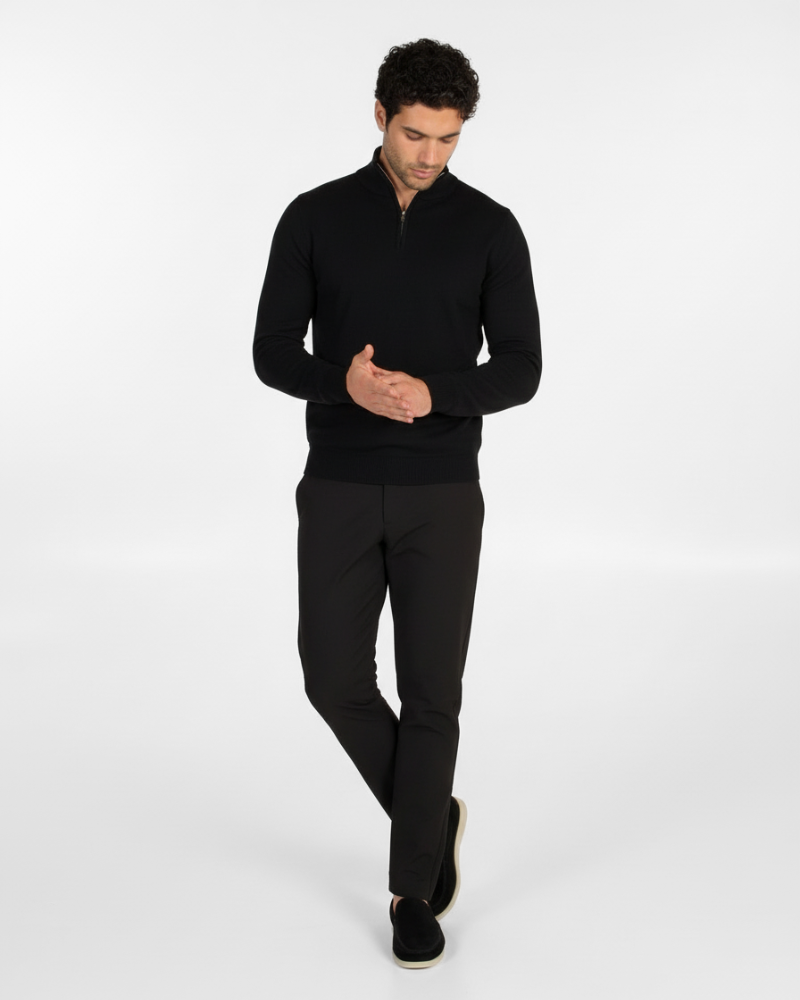 Minimalist luxury black wool knit half-zip sweater. Slim fit with ribbed hem and cuffs, paired with tailored trousers.