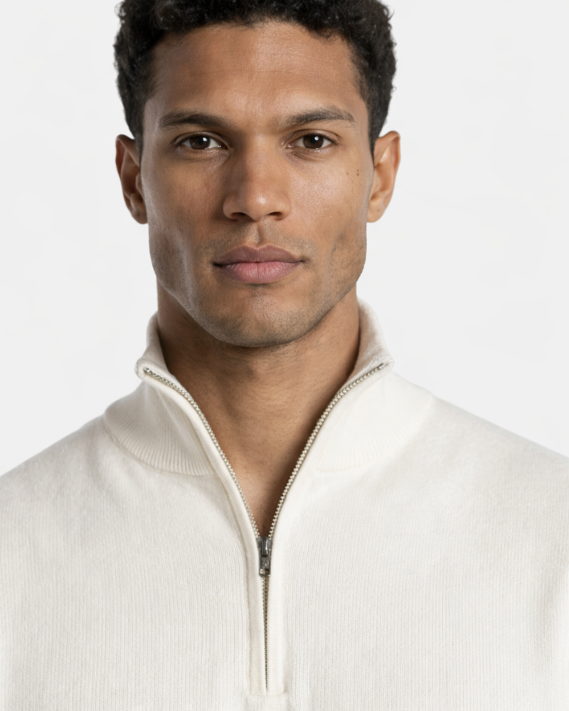 Luxury minimalist cream cashmere knit sweater with a ribbed mock neck and silver half-zip front for a refined fit.