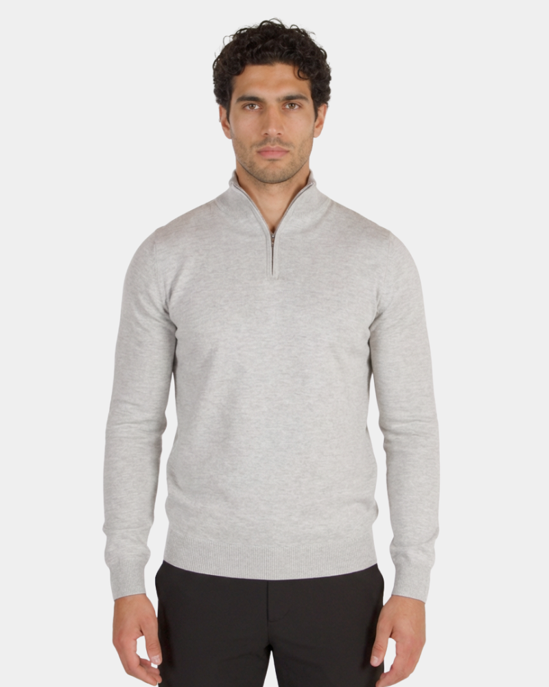 Minimalist luxury light grey cashmere knit half-zip sweater in a tailored fit with ribbed cuffs and collar.