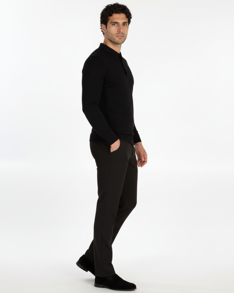Side view of luxury black merino wool knit polo. Minimalist slim fit with a refined drape and seamless collar profile.