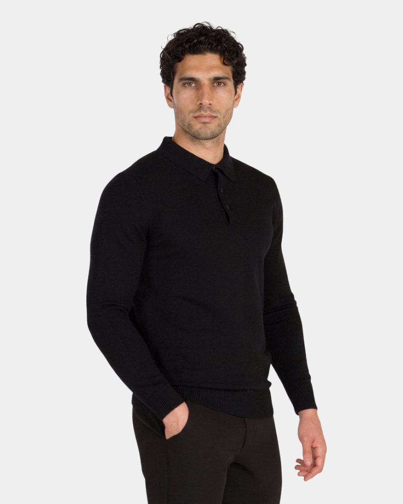 Luxury black merino wool knit polo in a minimalist slim fit. Features a refined three-button collar and ribbed hem.