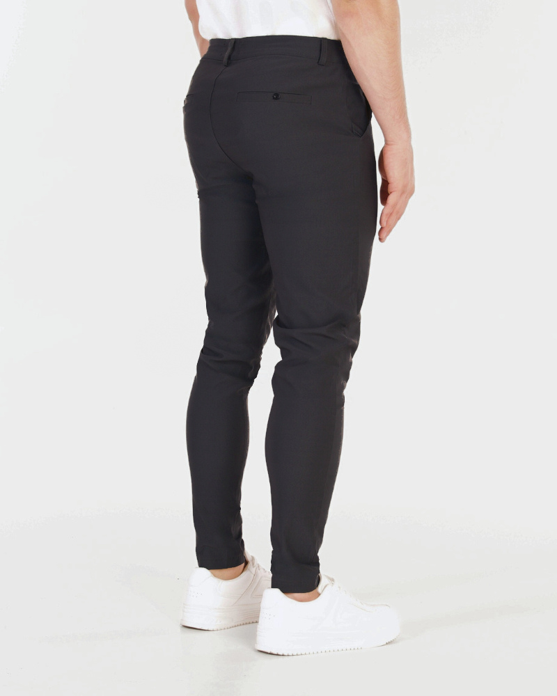 Minimalist luxury black stretch cotton chinos in a slim fit, featuring rear welt pockets and a smooth, tailored texture.