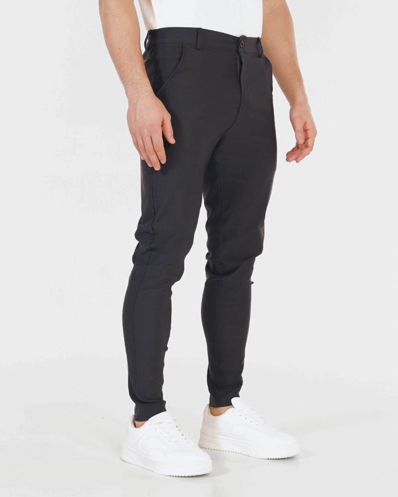 Minimalist luxury black stretch cotton chinos in a slim fit, featuring a smooth matte texture and tapered ankle.