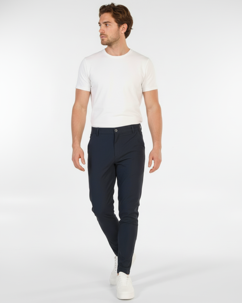Minimalist luxury navy chinos in a slim-fit stretch cotton twill, styled for a modern professional look.