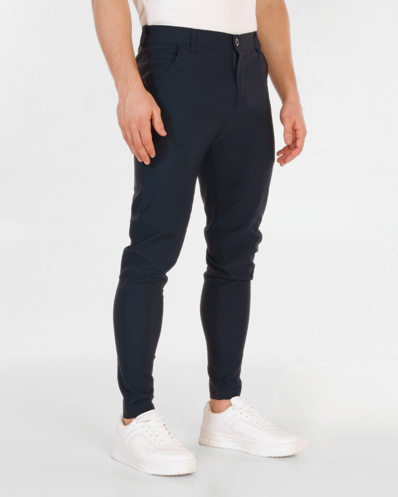 Minimalist navy luxury chinos in a slim-fit stretch cotton blend, styled with white sneakers for a refined aesthetic.