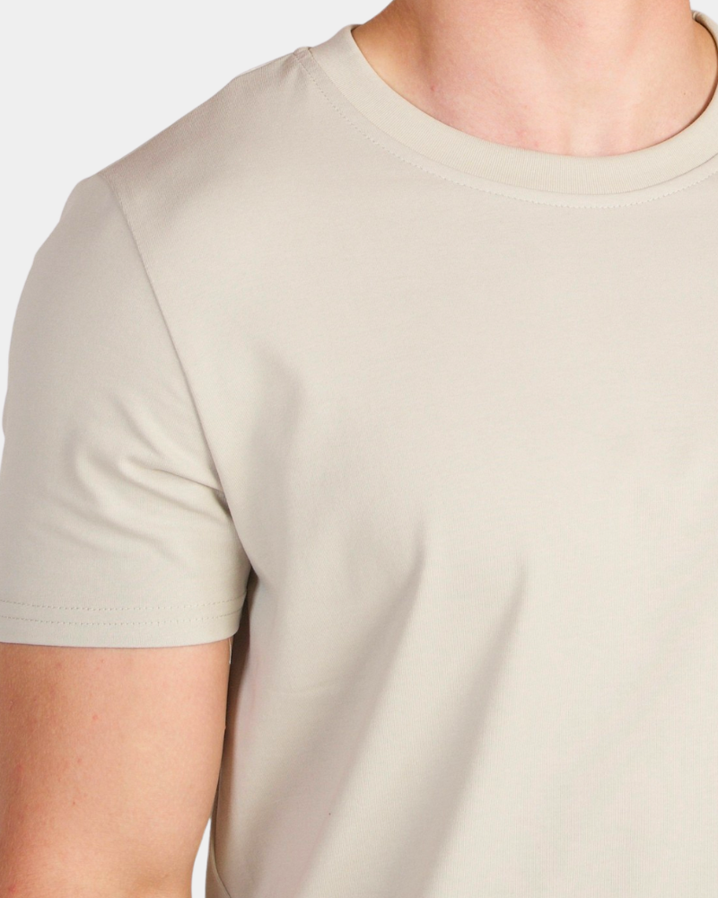 Macro view of sand luxury pima cotton Smart Fit T-shirt highlighting the premium finish and fabric density.