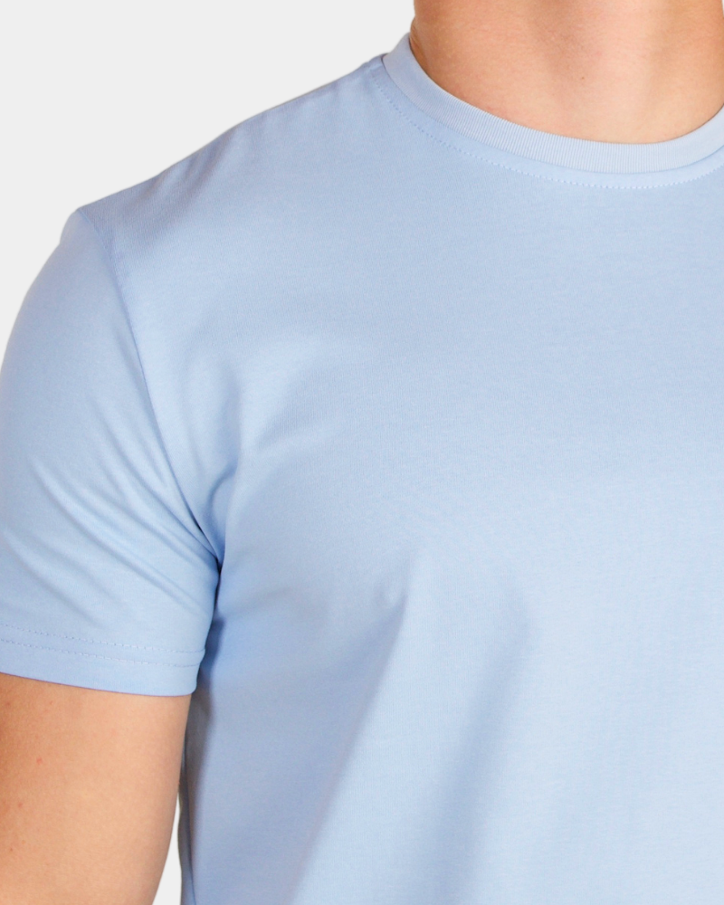 Macro shot of sky blue luxury pima cotton Smart Fit T-shirt highlighting the refined mercerized texture.