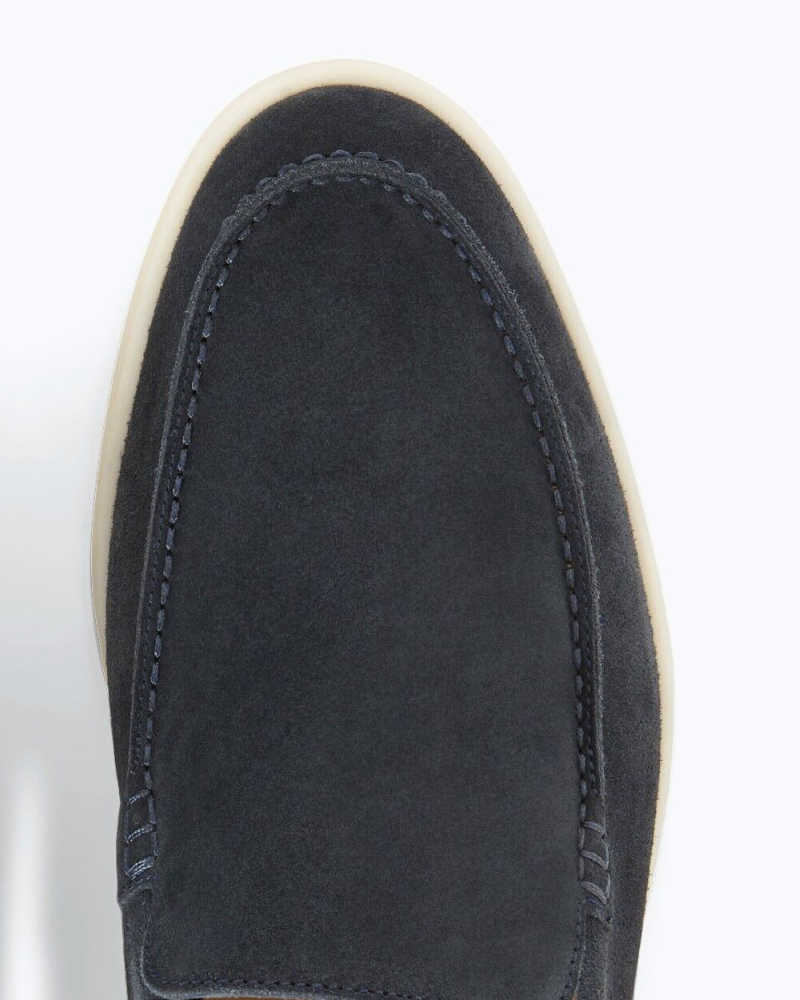 Close-up of By Alden luxury navy suede loafers showing premium texture, tonal minimalist stitching, and a sleek almond-toe fit. #color_navy
