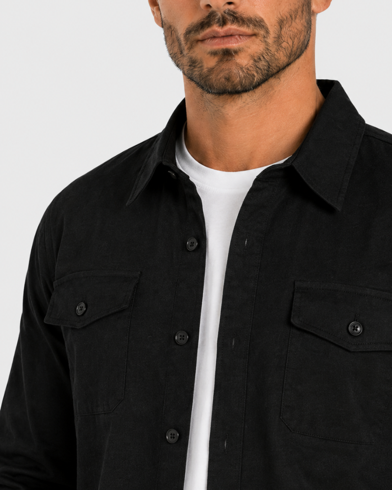 By Alden Black Overshirt worn by a White male model, close-up portrait view of collar and chest pocket detail, light grey background #Color_Black