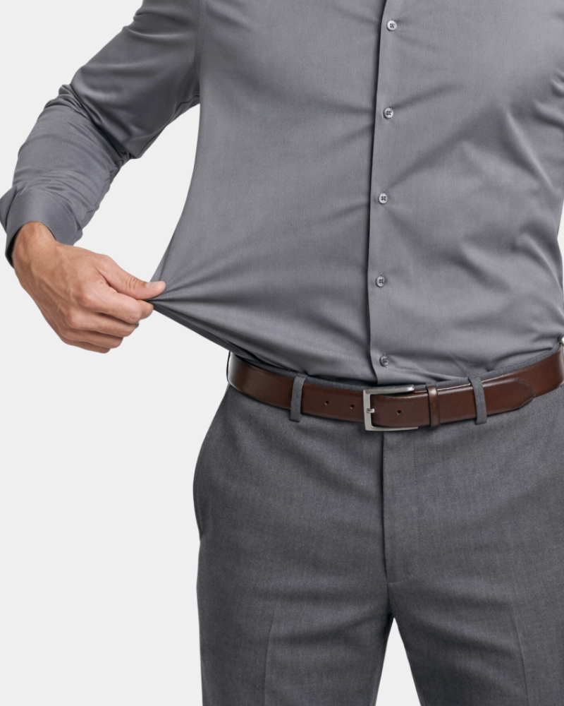 By Alden Charcoal Gray Slim Fit Dress Shirt worn by a male model, close-up front view showing stretch fabric detail, light grey background #color_gray