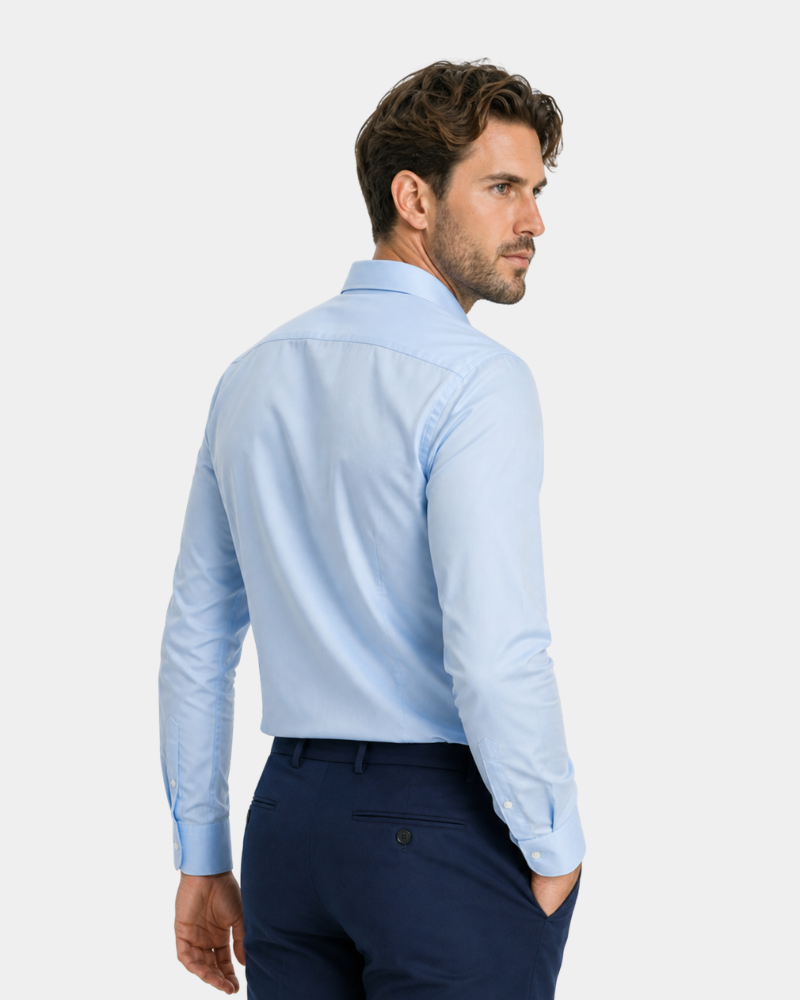 By Alden Light Blue Slim Fit Dress Shirt worn by a White male model, cropped back angle view, light grey background #Color_light blue