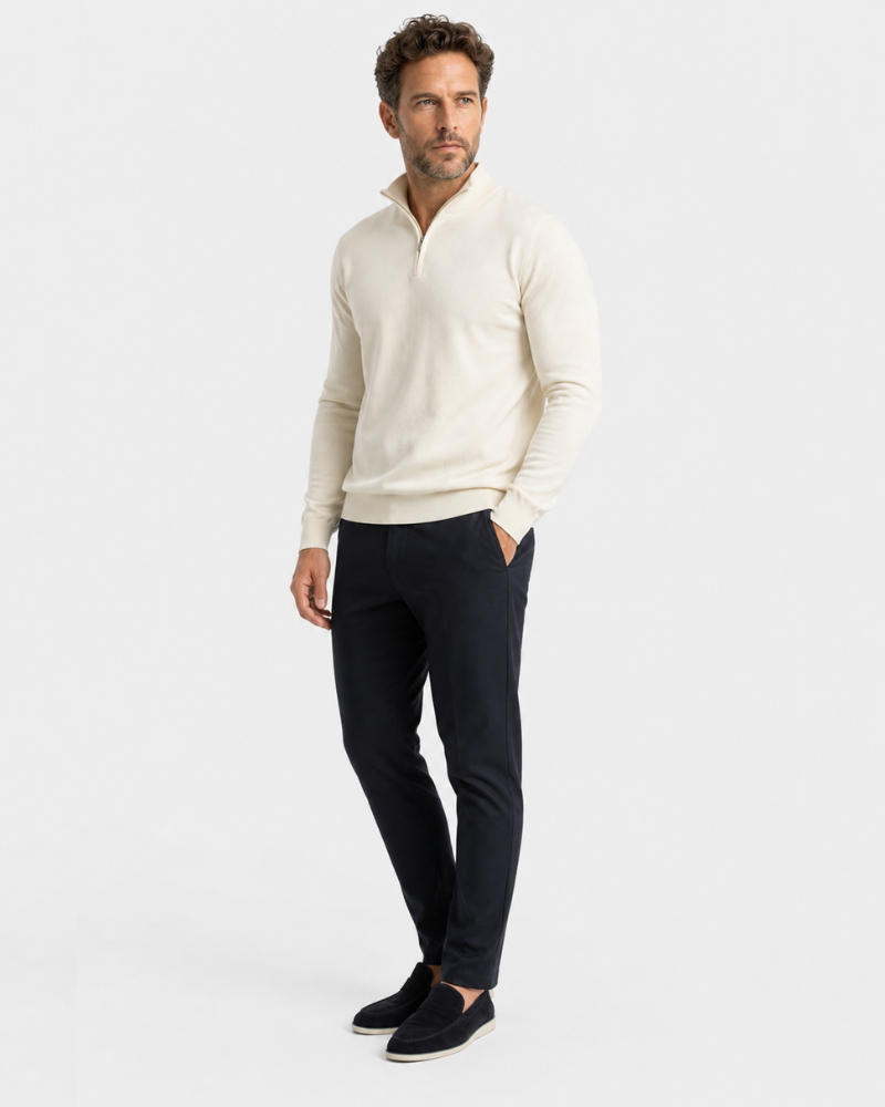 Man wearing a By Alden beige sweater and black pants on a white background #color_beige