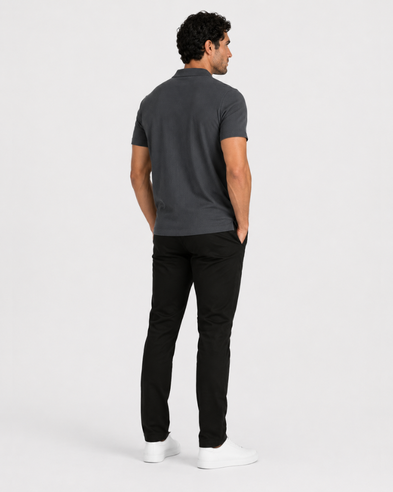 Man wearing a By Alden dark gray polo shirt and black pants on a white background #Color_dark gray