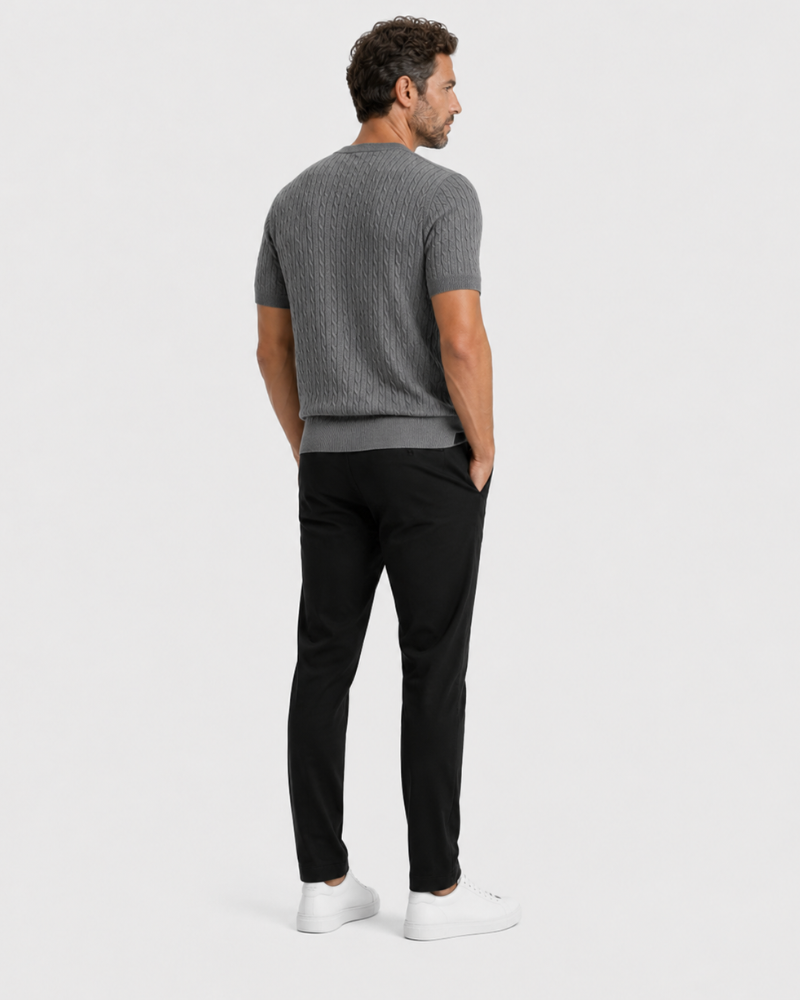Man wearing a By Alden gray sweater and black pants on a white background #color_gray