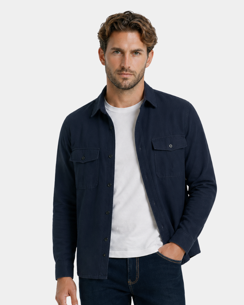 Man wearing a By Alden navy blue shirt over a white t-shirt on a light gray background #color_navy