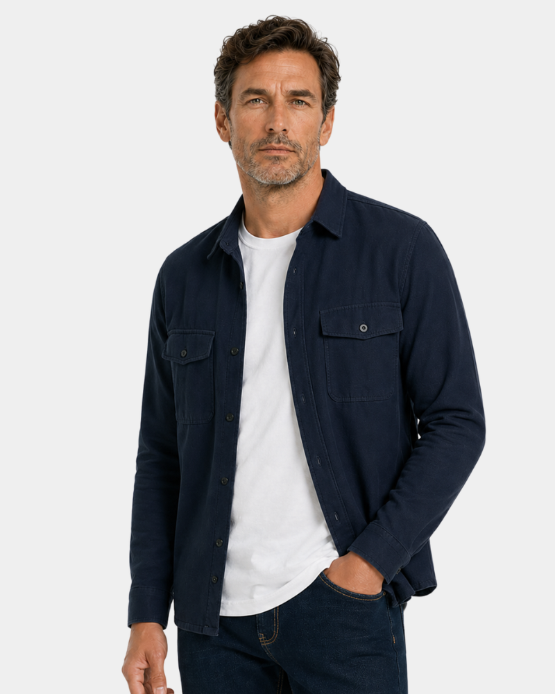 Man wearing a By Alden navy blue shirt over a white t-shirt on a light gray background #color_navy