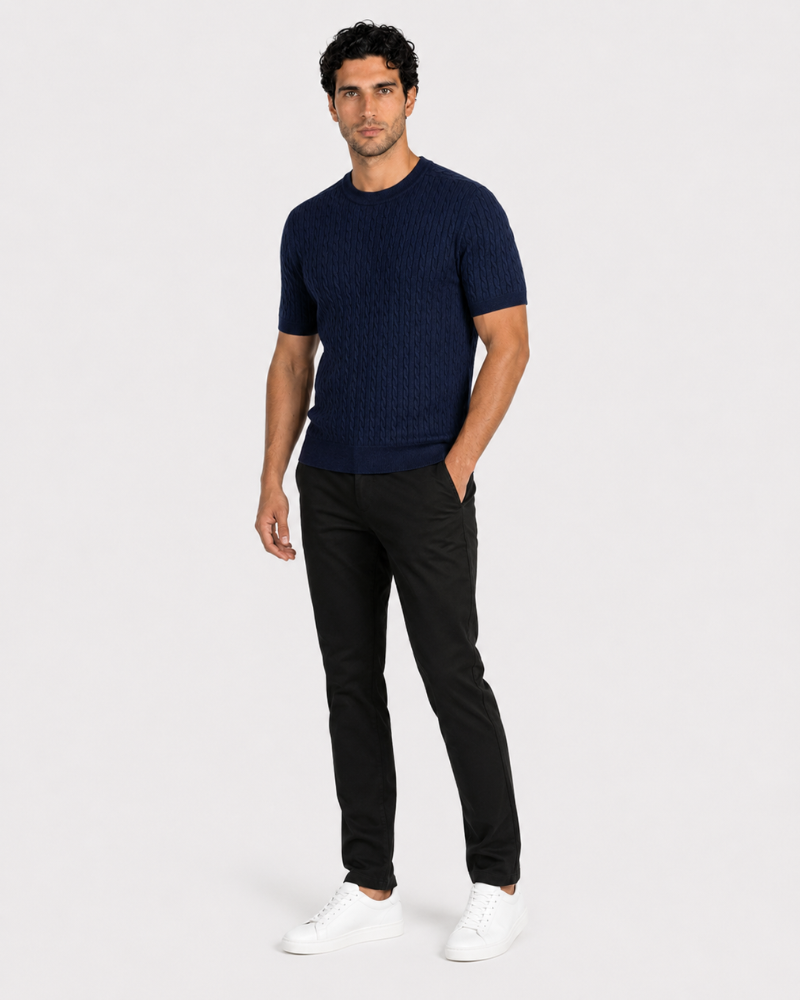 Man wearing a By Alden navy blue sweater and black pants on a white background #color_navy