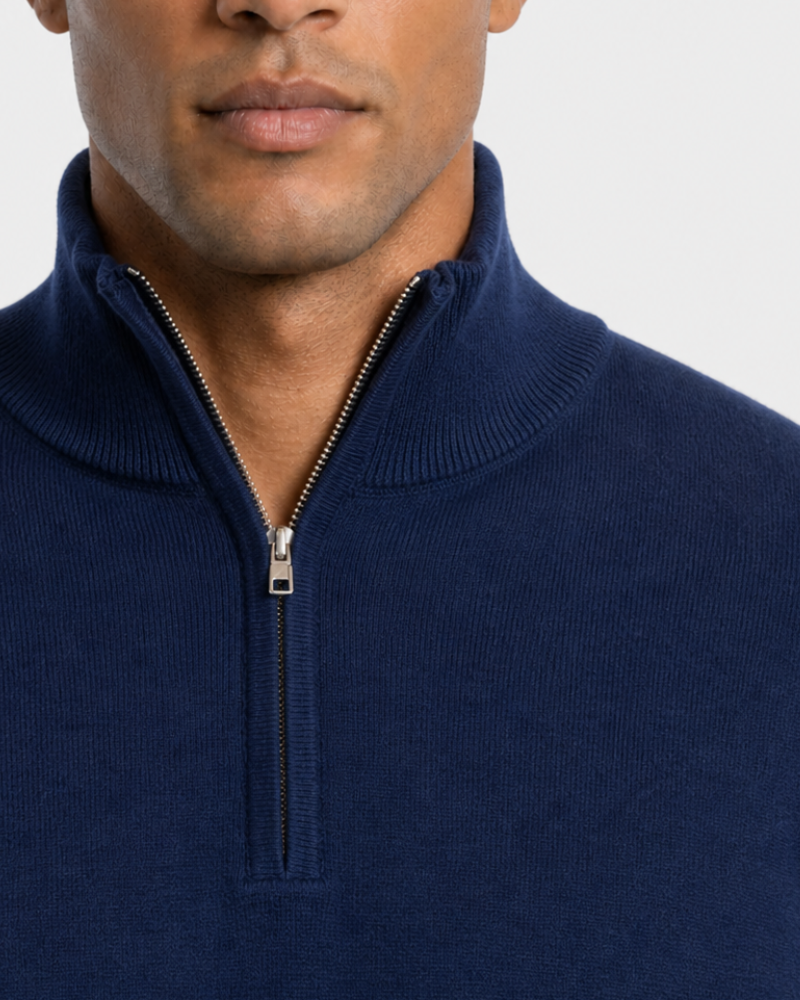 Man wearing a By Alden navy blue zip-up sweater against a light gray background #color_navy