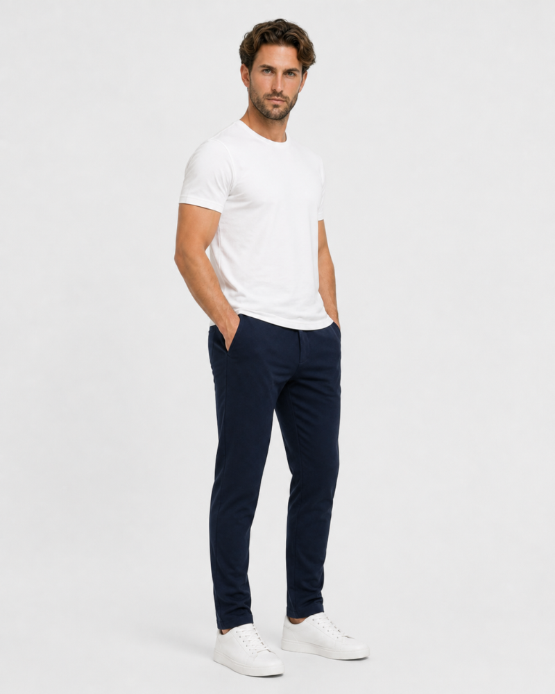 Man wearing a By Alden white t-shirt and navy pants on a light gray background #Color_navy