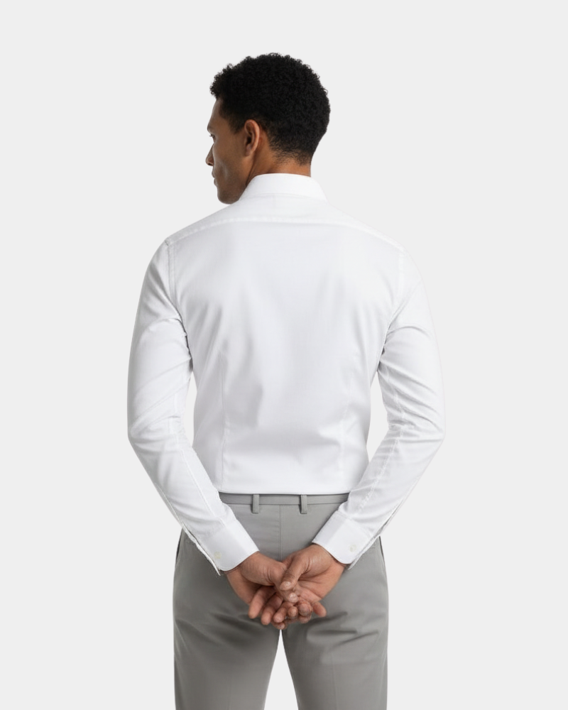 By Alden White Slim Fit Dress Shirt worn by a Black male model, cropped back view, light grey background #color_white