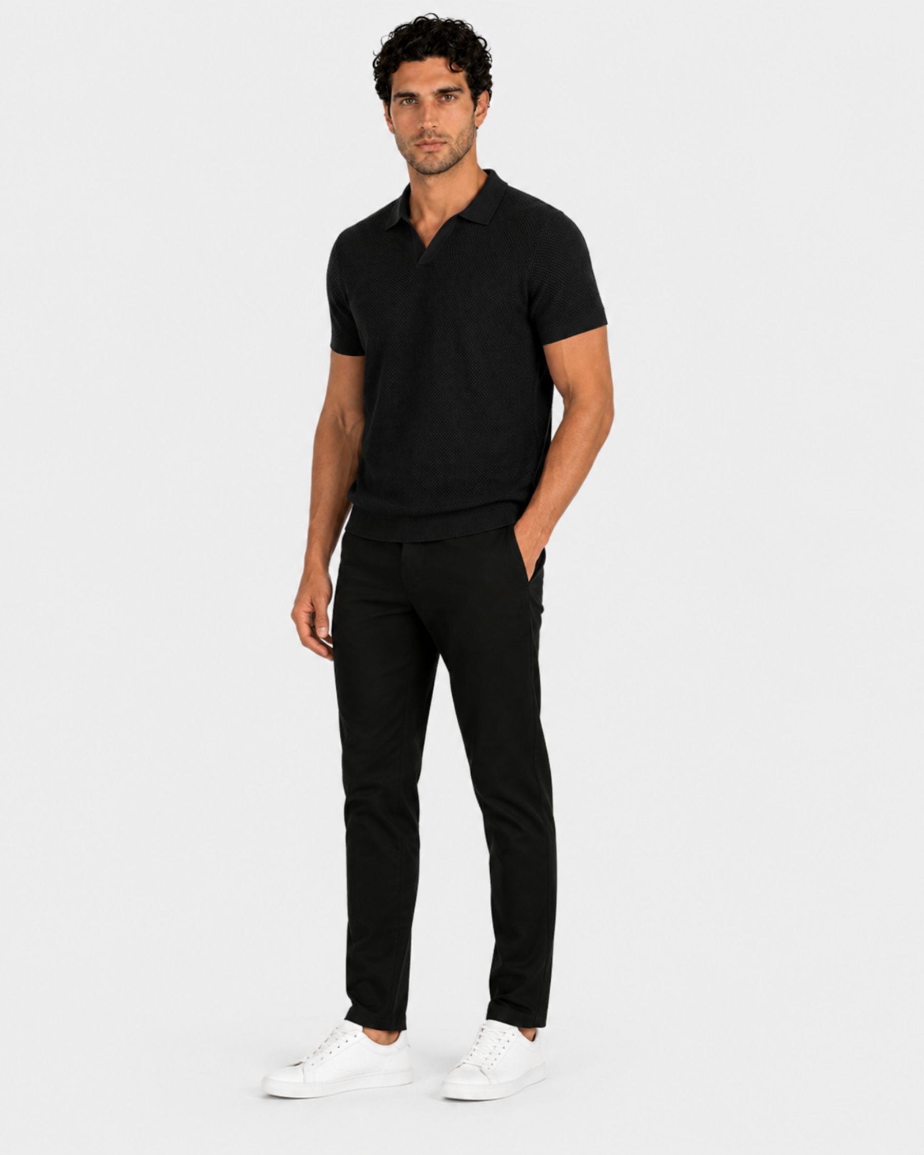 By Alden black open-collar knit polo shirt on male model, three-quarter view, full body, light gray background. #Color_black
