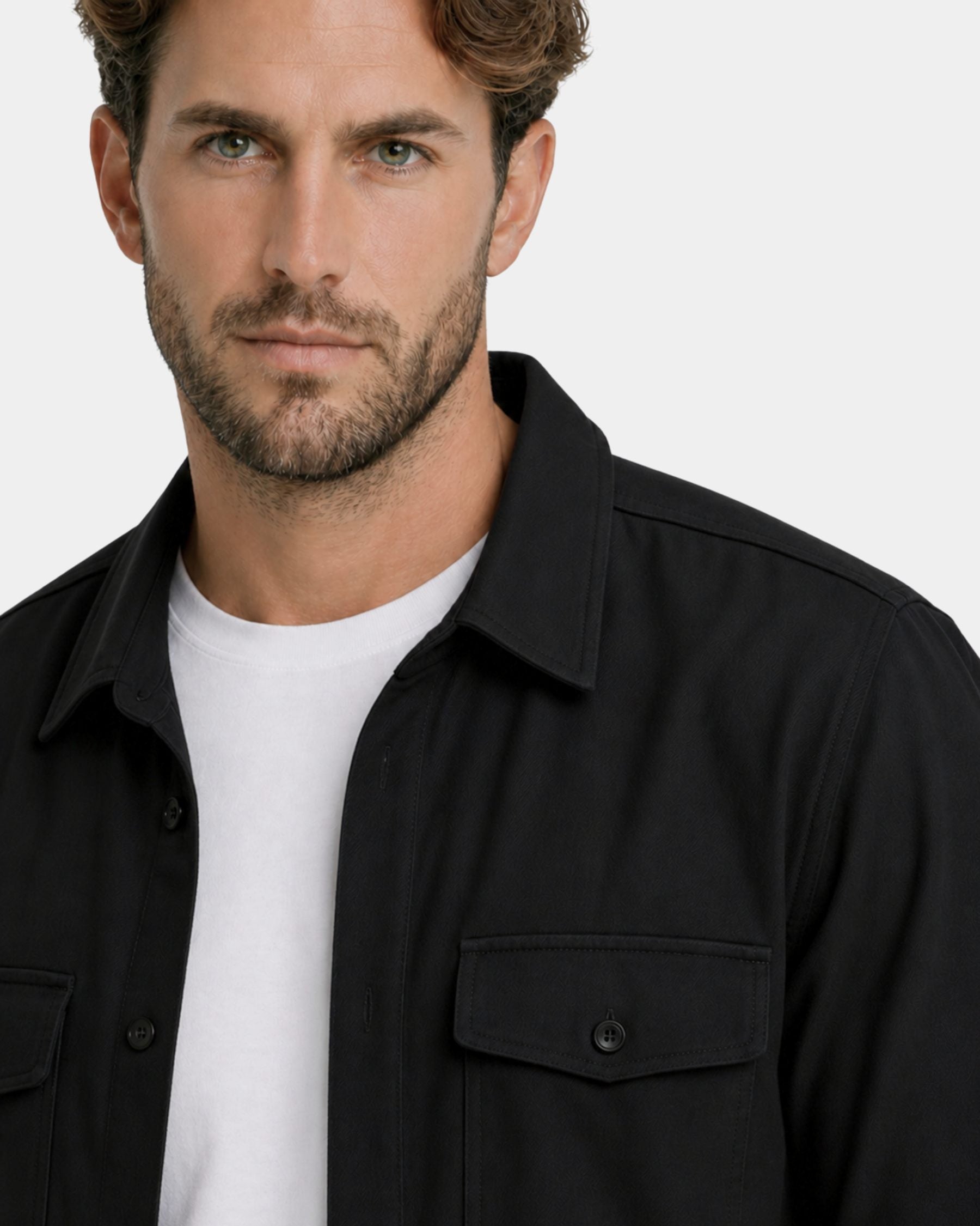 By Alden black overshirt on male model, close-up detail of collar and chest pocket, light gray background #Color_black