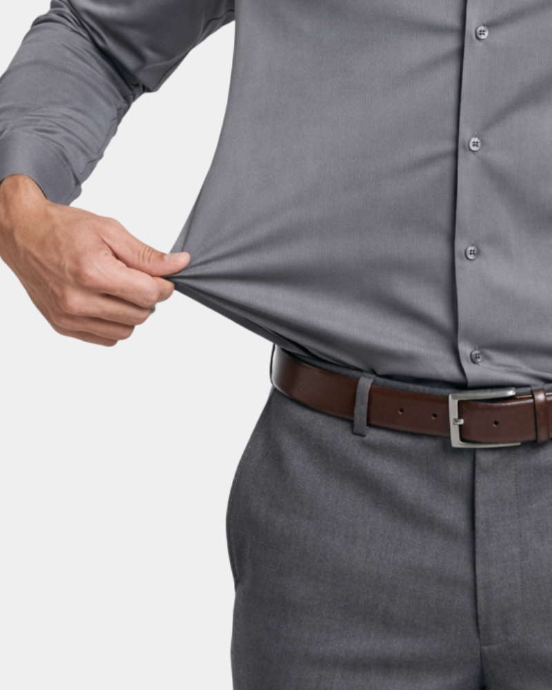 By Alden gray stretch dress shirt fabric detail, male model pulling fabric, front close-up, light gray background. #color_gray
