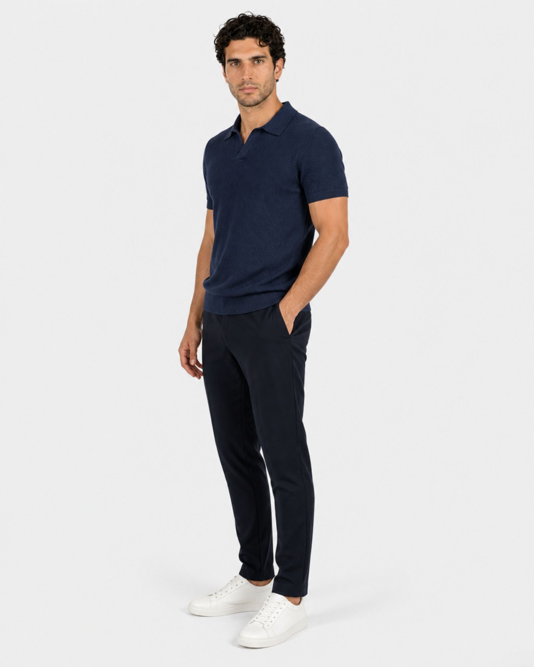 By Alden navy blue open-collar knit polo shirt on male model, three-quarter view, full body, light gray background. #Color_navy