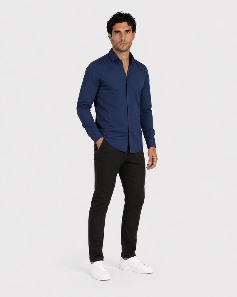 By Alden navy slim-fit dress shirt on male model, three-quarter view, full body, light gray background. #color_navy