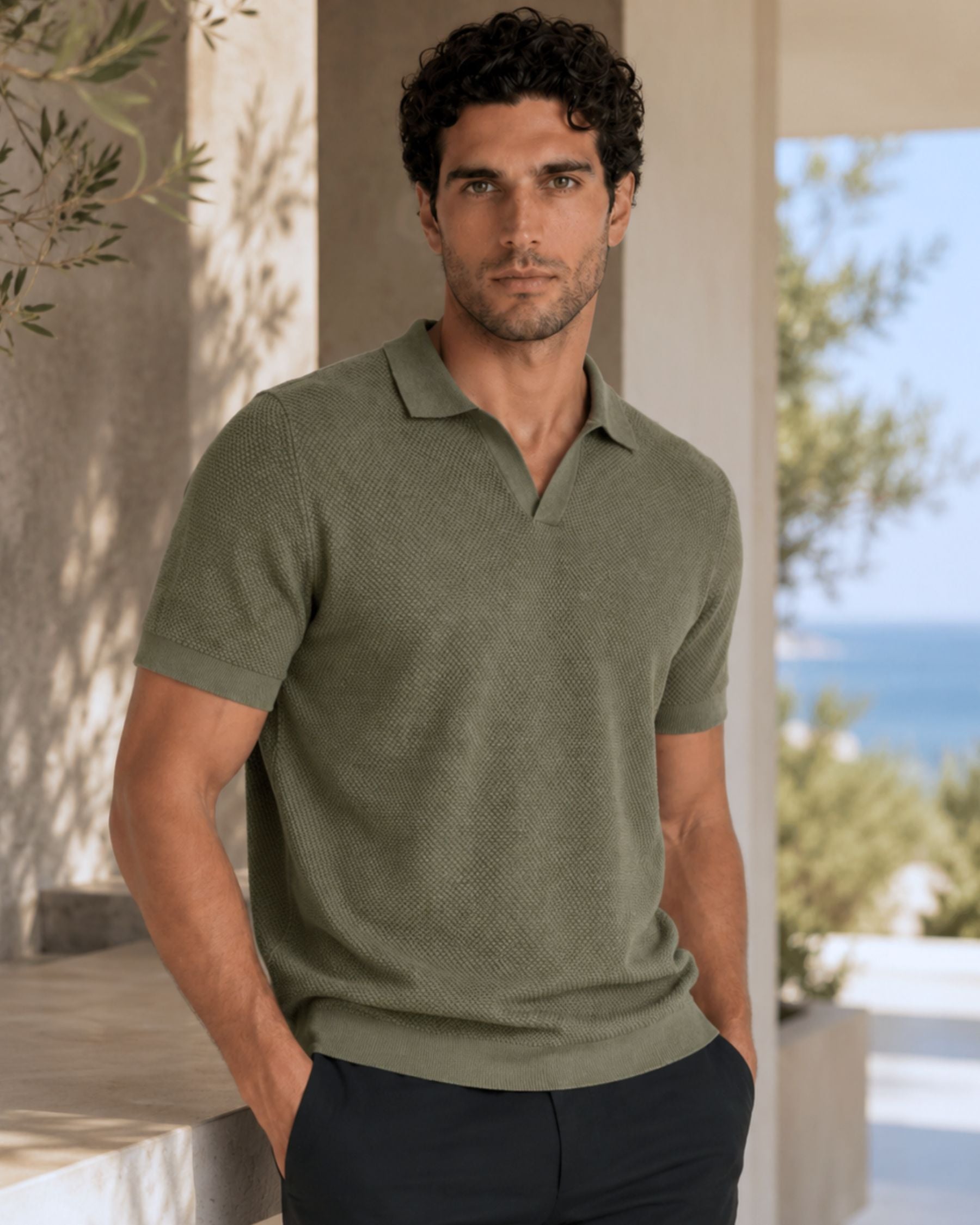 By Alden olive green open-collar knit polo shirt on male model, front view, upper body, outdoor blue sea background. #Color_olive green