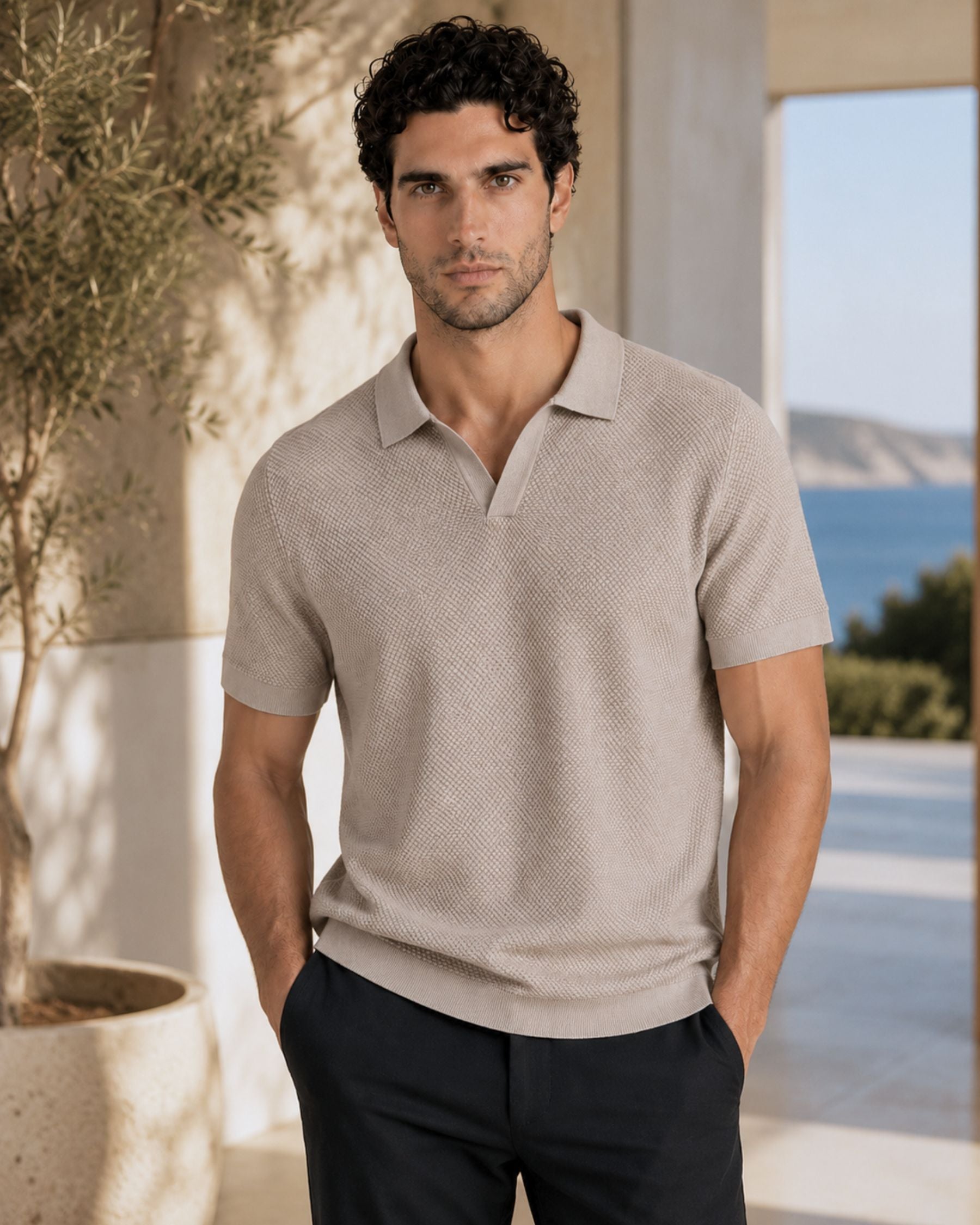 By Alden sand open-collar knit polo shirt on male model, front view, upper body, outdoor blue sea background. #Color_deep stone