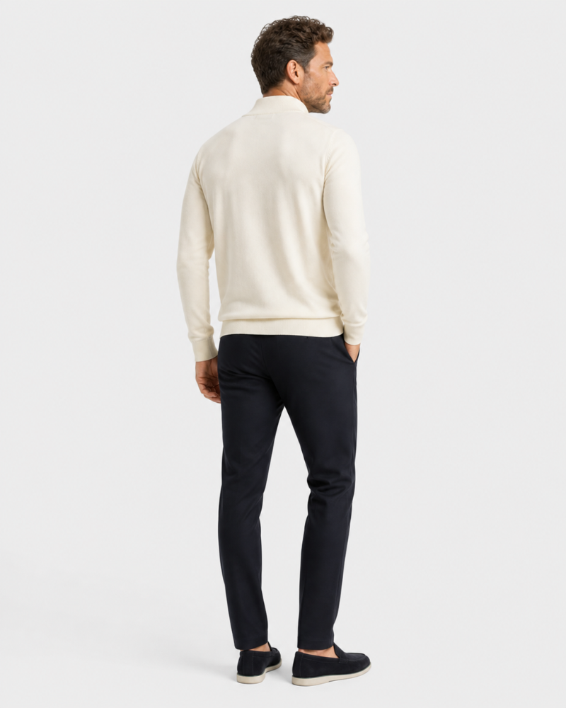 Man wearing a By Alden beige sweater and black pants on a white background #color_beige