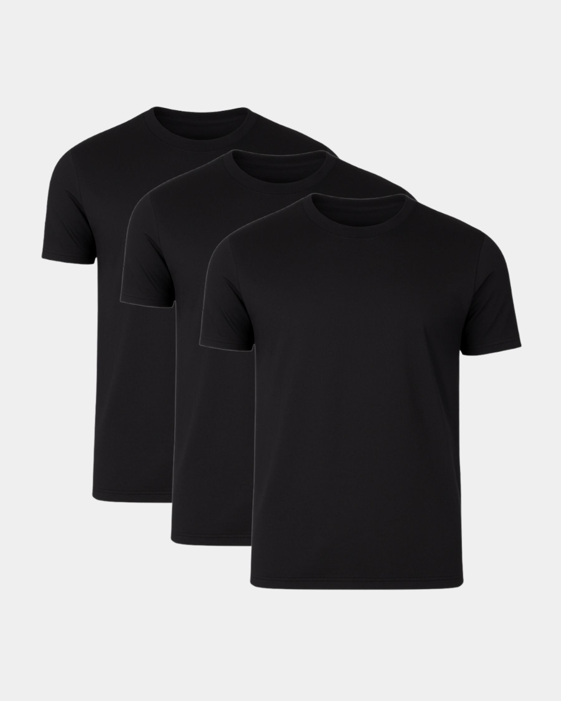 Three black t-shirts stacked on a light gray background