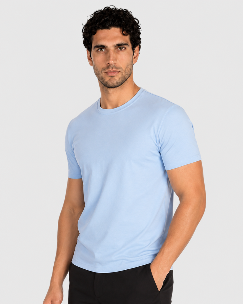 By Alden light blue crew neck t-shirt on male Caucasian model, 3/4 angle, gray bg #Color_light blue #Mixed_summer colors