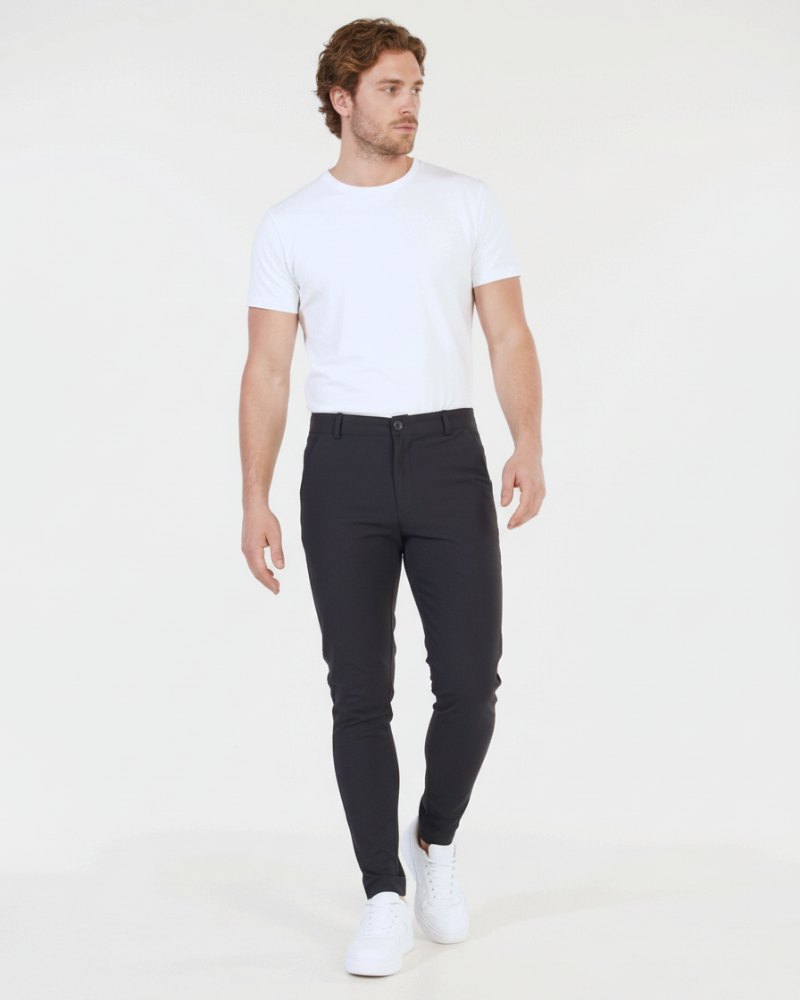 Minimalist luxury black stretch cotton chinos in a slim fit, featuring a smooth matte texture for a refined look.