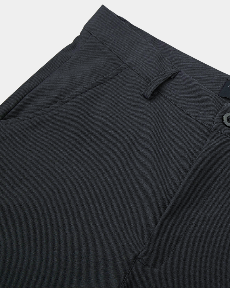 Minimalist luxury charcoal chinos in textured stretch twill with a tailored waist and premium slant pocket detailing.