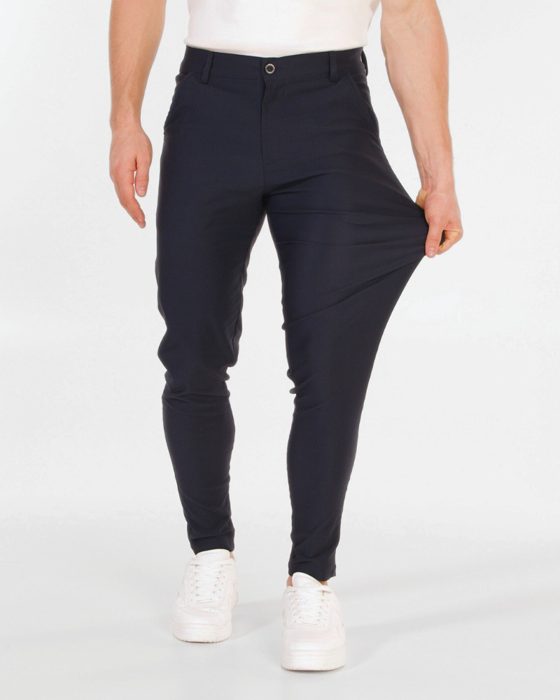 Minimalist luxury navy chinos in a flexible stretch cotton blend, demonstrating a slim fit and premium durability.