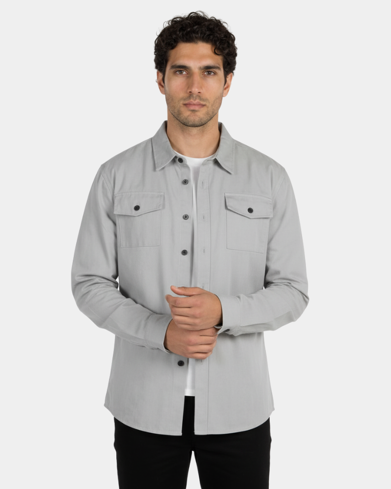 Minimalist luxury stone grey twill overshirt with a structured fit, dual chest pockets, and a refined textile finish.