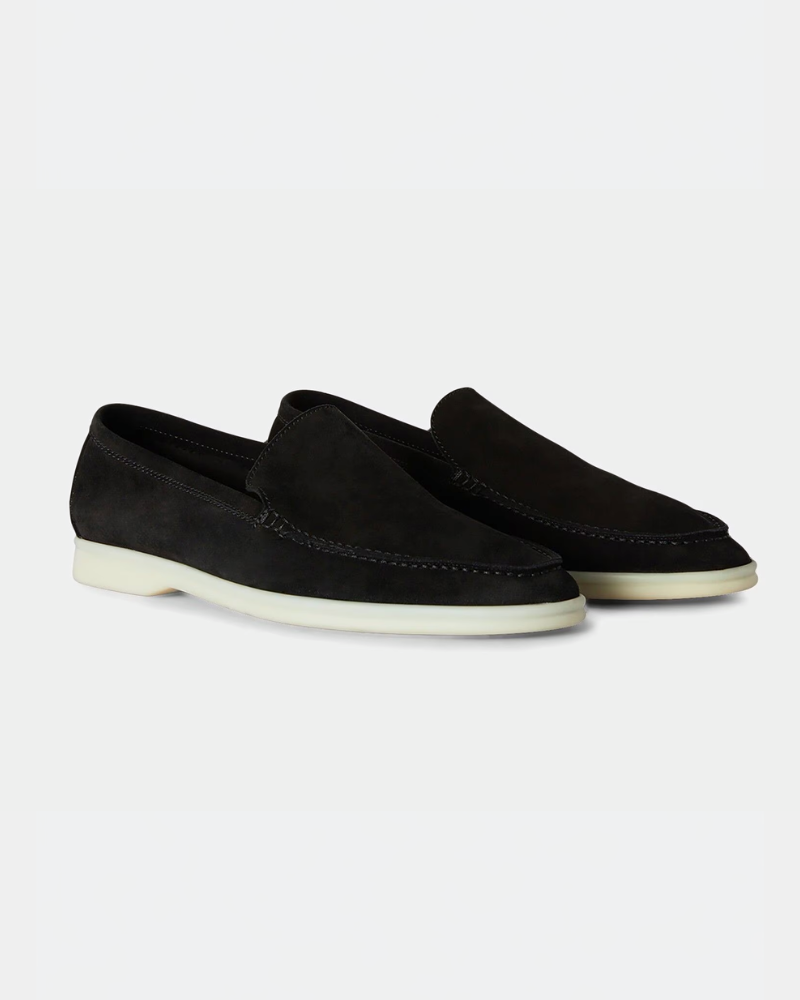 Luxury black suede yacht loafers with minimalist white soles, showcasing an elegant slip-on fit and premium texture.