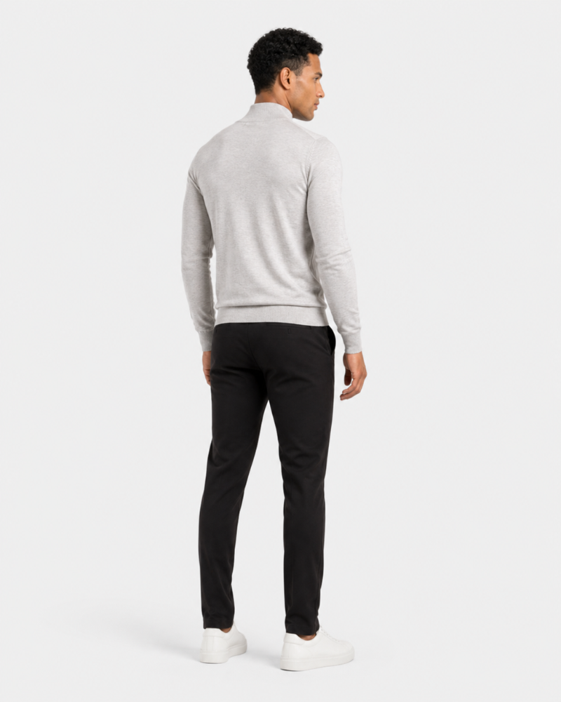 Man wearing a By Alden light gray sweater and black pants on a white background #color_gray