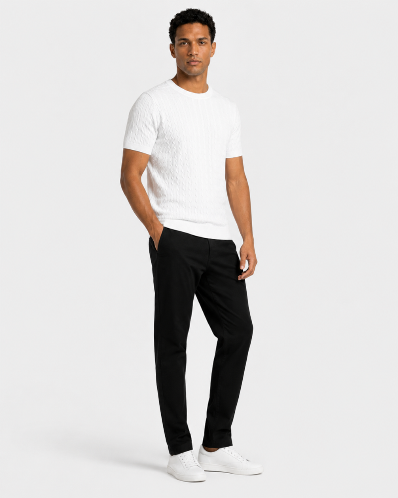 Man wearing a By Aldeb white t-shirt and black pants on a white background #color_white