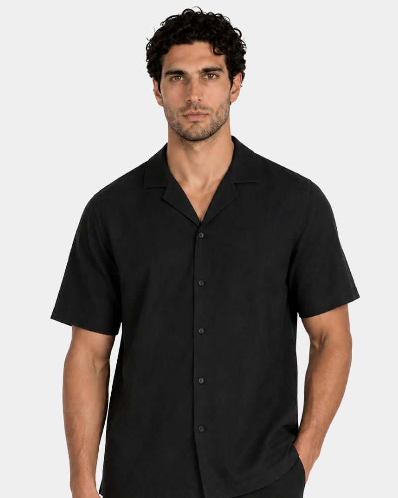 By Alden Black Linen Camp Collar Shirt worn by a male model, cropped front view, light grey background #Color_black