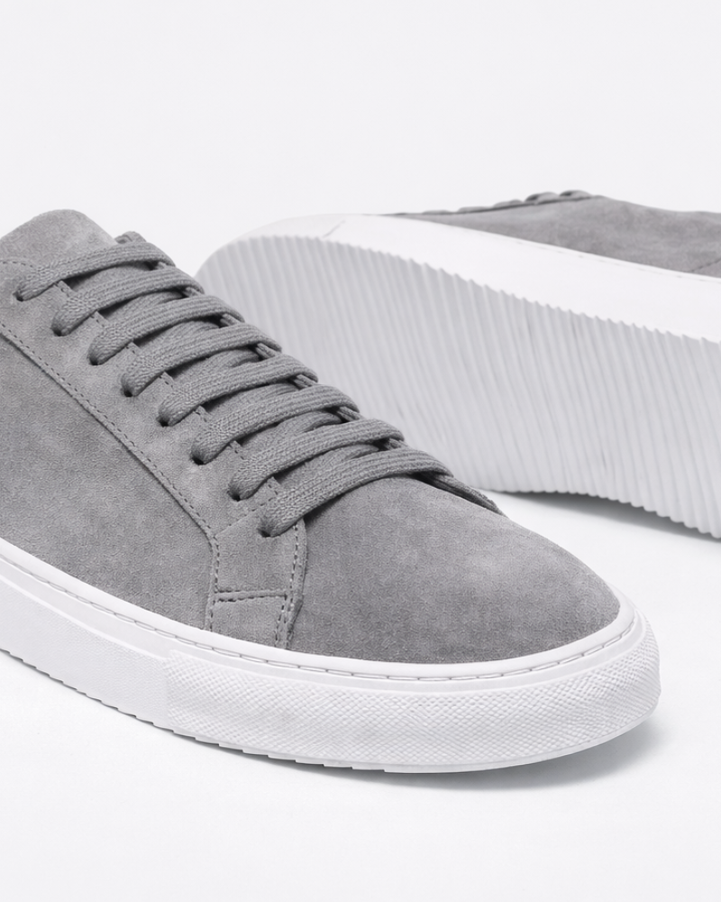 By Alden Gray Suede Classic Trainers, close-up angled view of toe and sole detail, white background #color_gray