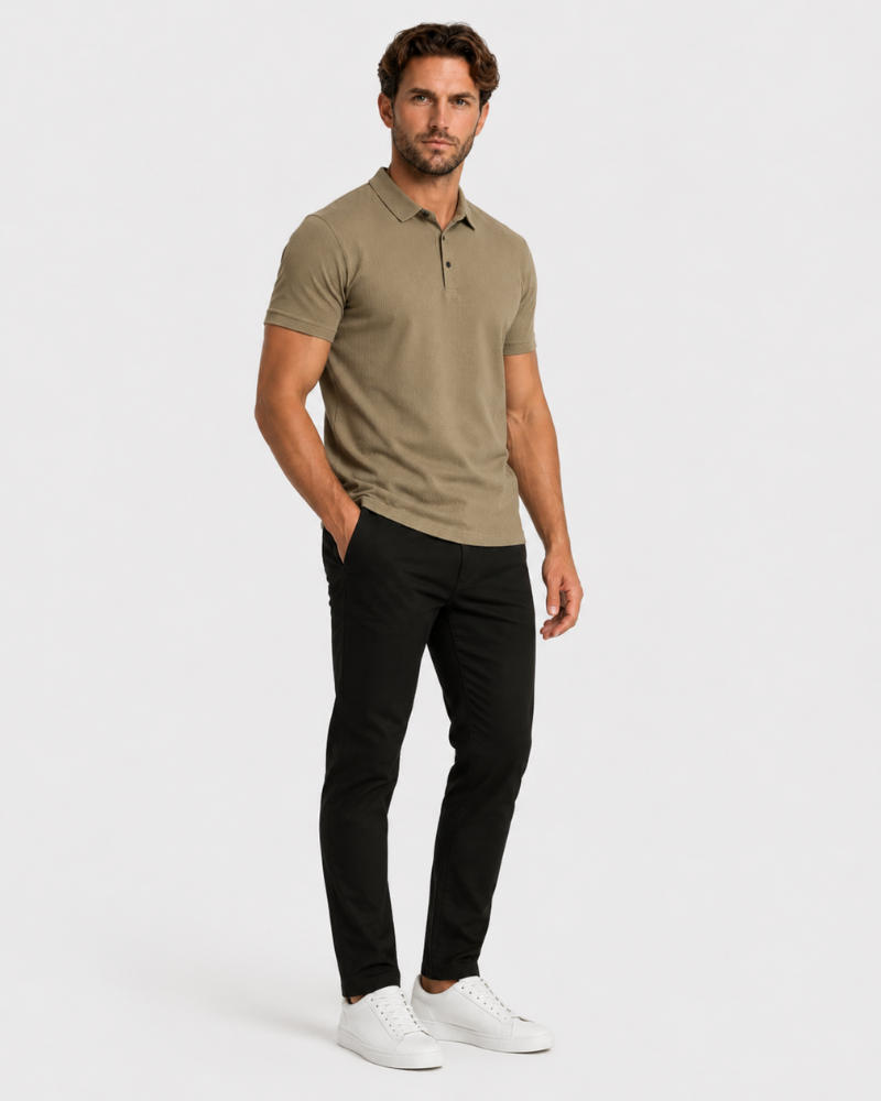 Man wearing a By Alden beige polo shirt and black pants on a white background #Color_camel