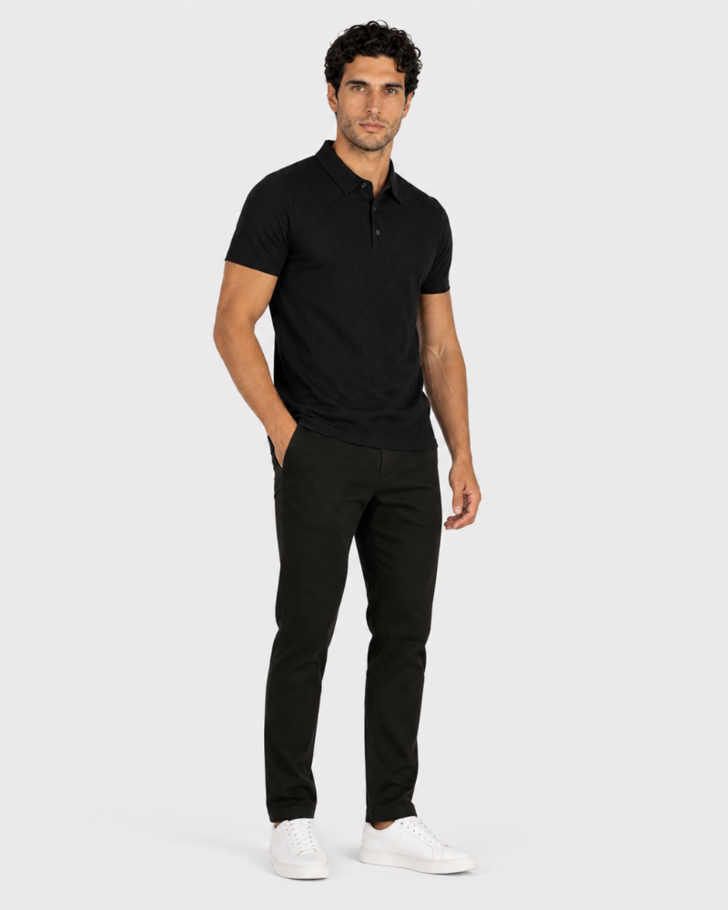 Man wearing a By Alden black polo shirt and pants on a white background #Color_black
