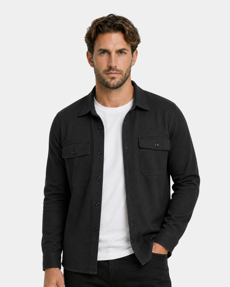 Man wearing a By Alden black shirt over a white t-shirt on a light gray background #color_black