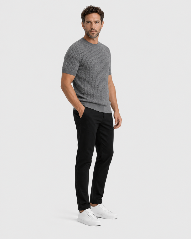 Man wearing a By Alden gray patterned shirt, black pants, and white shoes on a light gray background #color_gray