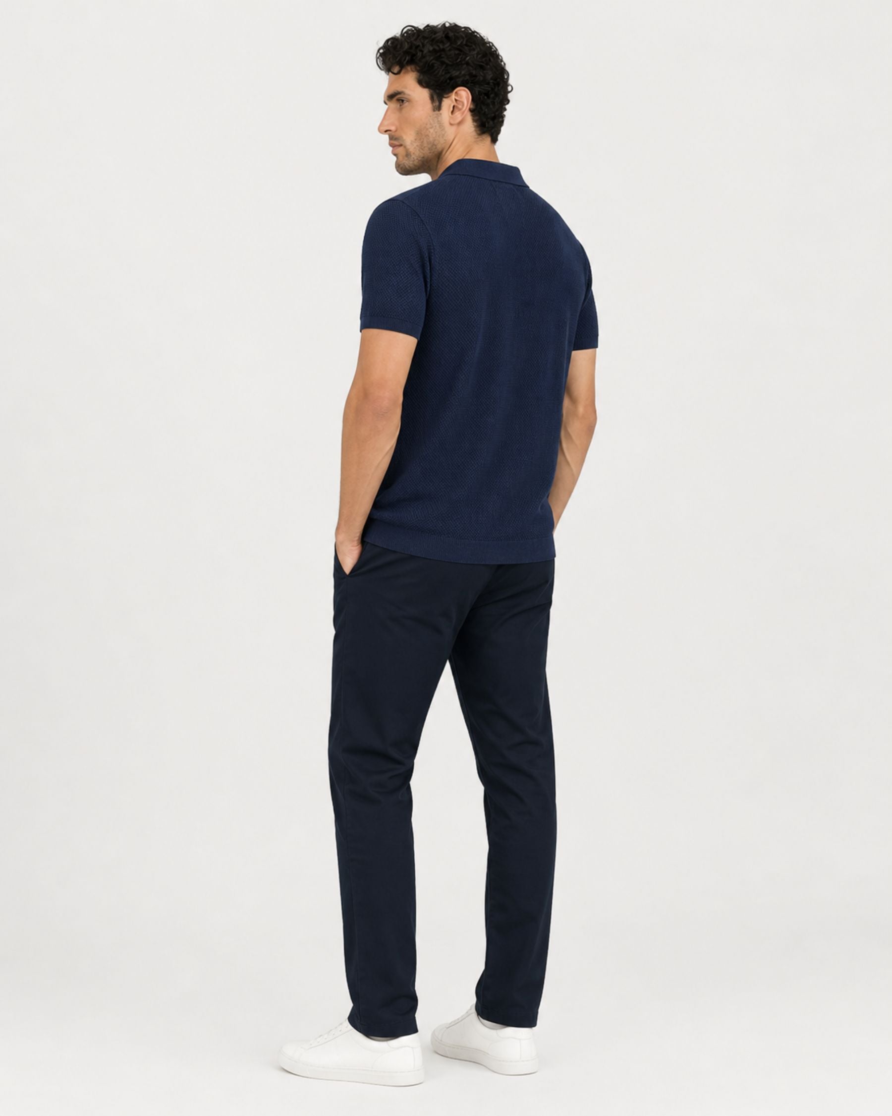 By Alden navy blue open-collar knit polo shirt on male model, back view, full body, light gray background. #Color_navy