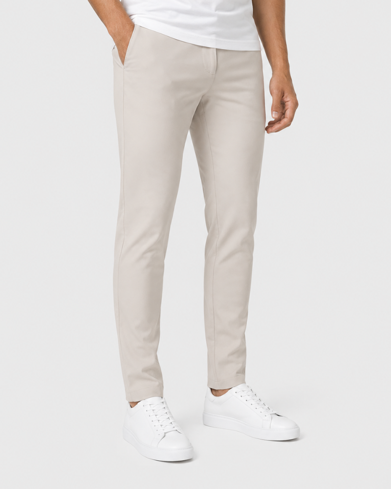 By Alden stone slim-fit chino trousers on male model, three-quarter view, full body, light gray background.
#Color_beige